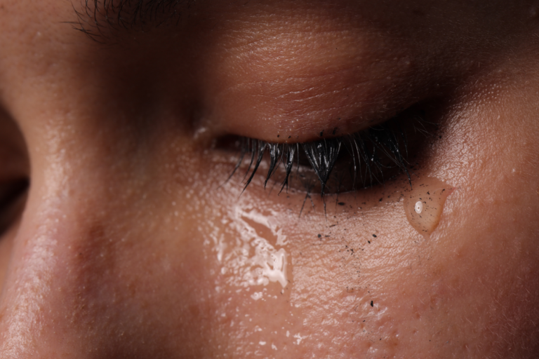 Person with tears on their eyes.